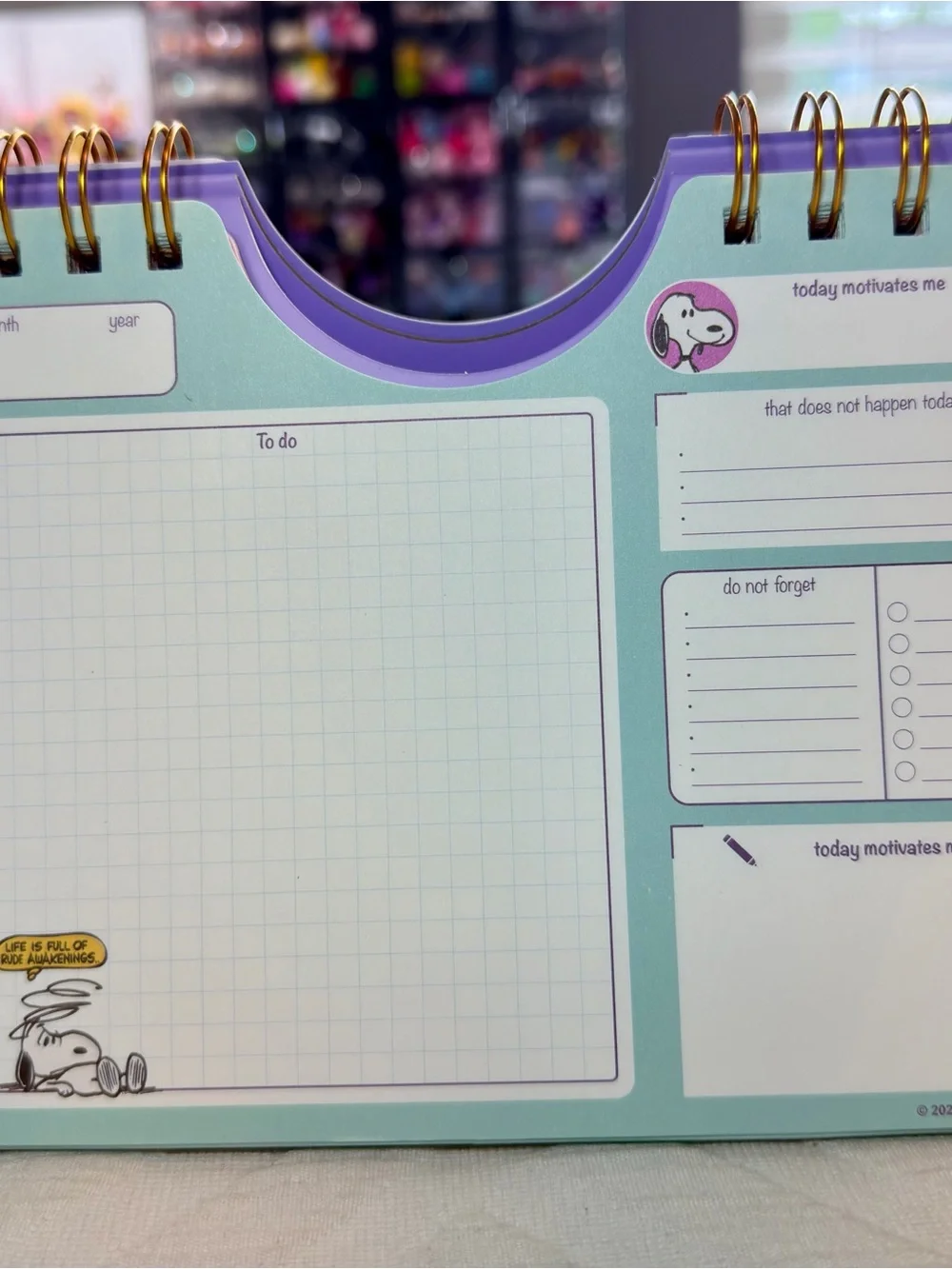 Peanuts Desk Calendar — Purple Cover with Teal Logo